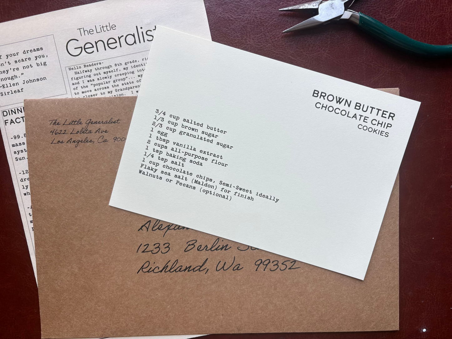 Letterhead paper with text on a brown surface with a pair of scissors.