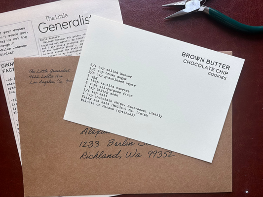 Letterhead paper with text on a brown surface with a pair of scissors.